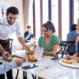 Group of diverse friend talking and eating food together in restaurant. Attractive young man and woman people feel happy and relax, having fun hangout indoors enjoy meeting reunion in cafe cafetaria.